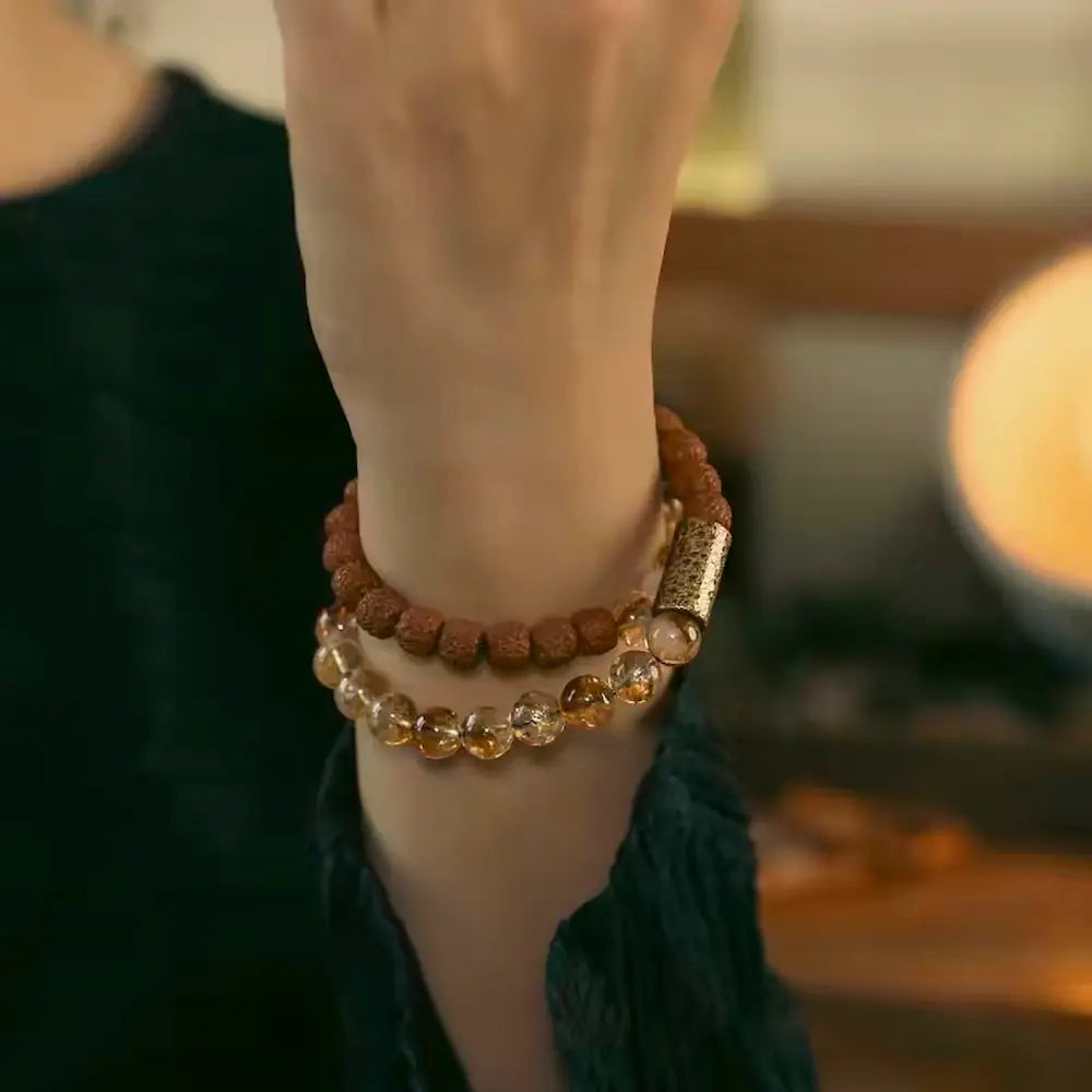 Double-layer rudraksha and citrine meditation bracelet with hammered copper tube worn on wrist