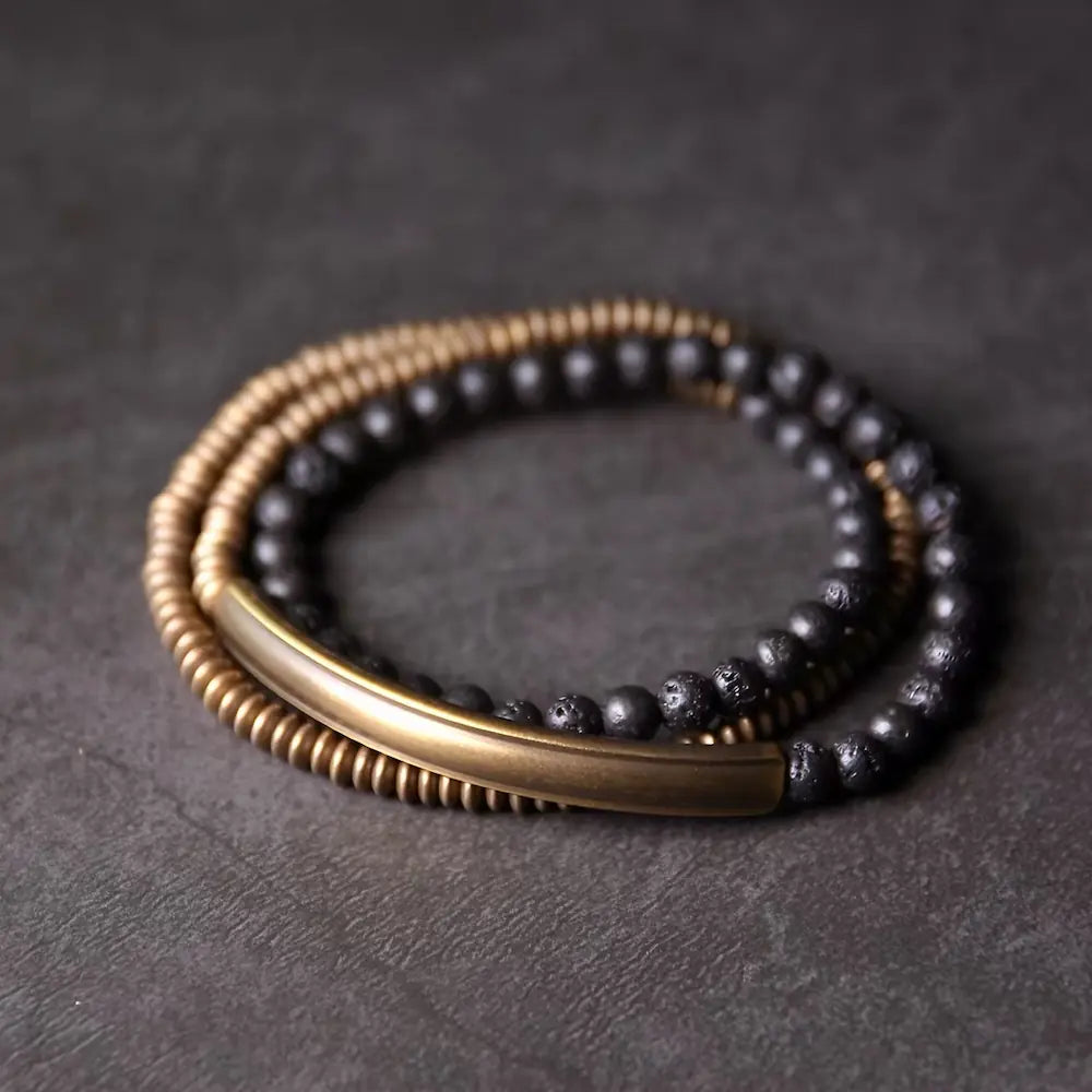 Handcrafted black lava rock and brass bead bracelet with curved brass tube connector — Orienlu