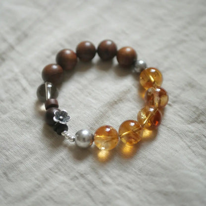 Handcrafted citrine bracelet with golden sandalwood beads and silver flower charm — Orienlu