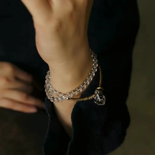 Double-layer clear quartz bracelet with pendants worn as stacked wrist look — Orienlu