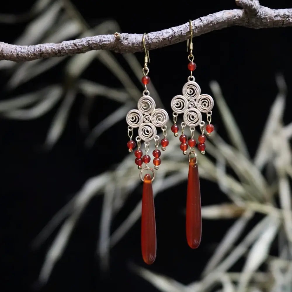 Copper hook filigree clover earrings with red agate beads on natural branch background Orienlu