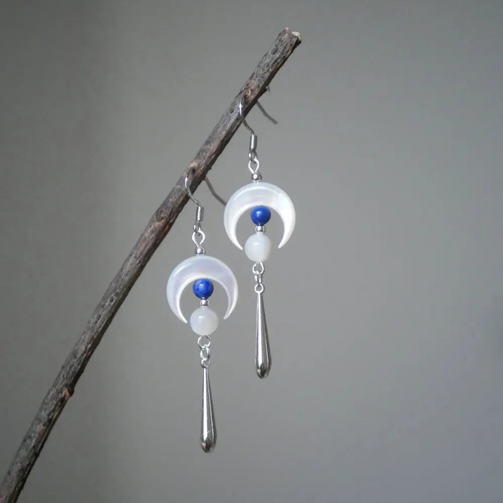 Dangle moon earrings hanging on a branch showing silver cone drop pendant Orienlu
