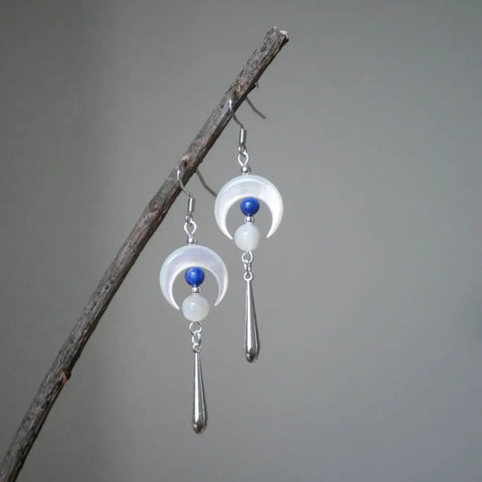 Dangle moon earrings hanging on a branch showing silver cone drop pendant Orienlu
