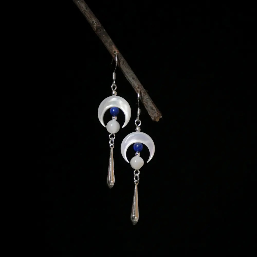 Silver moon earrings with mother of pearl crescent and lapis lazuli drop on dark background Orienlu