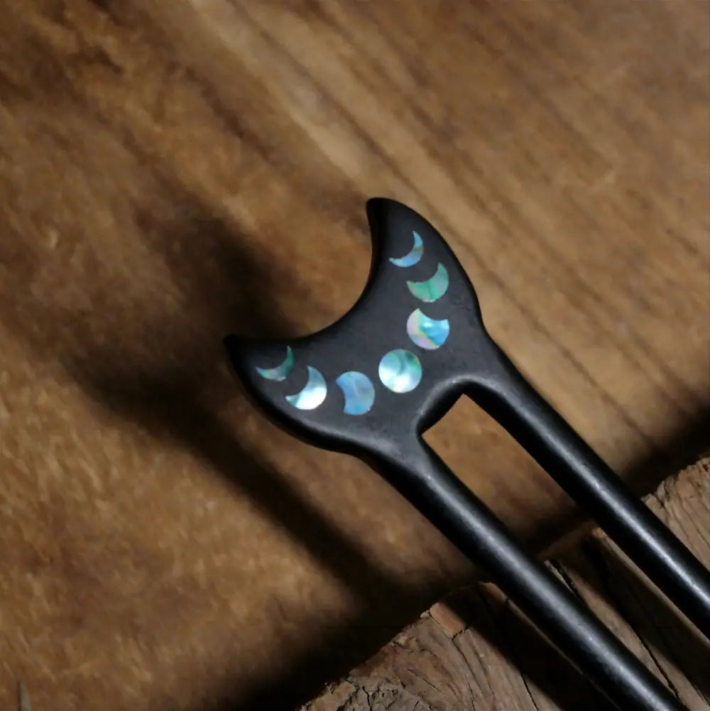 Close-up of moon phase abalone shell and mother of pearl inlay on ebony hair fork top Orienlu