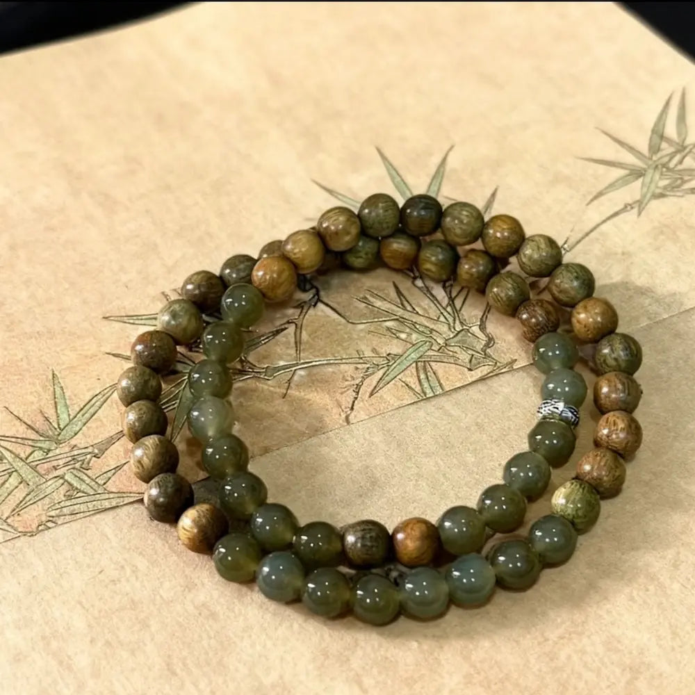 Green sandalwood and hetian jade double wrap bracelet on traditional background Orienlu