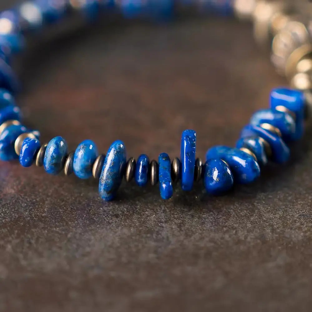 Detailed close-up of irregular natural blue lapis lazuli chip beads and brass disc spacers — Orienlu