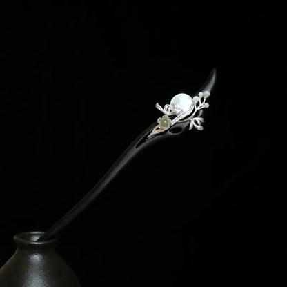 Orienlu official main product image of an 18cm ebony wood hair stick, featuring a silver-plated vine design with a round white mother of pearl moon and a carved green Hetian jade flower charm.