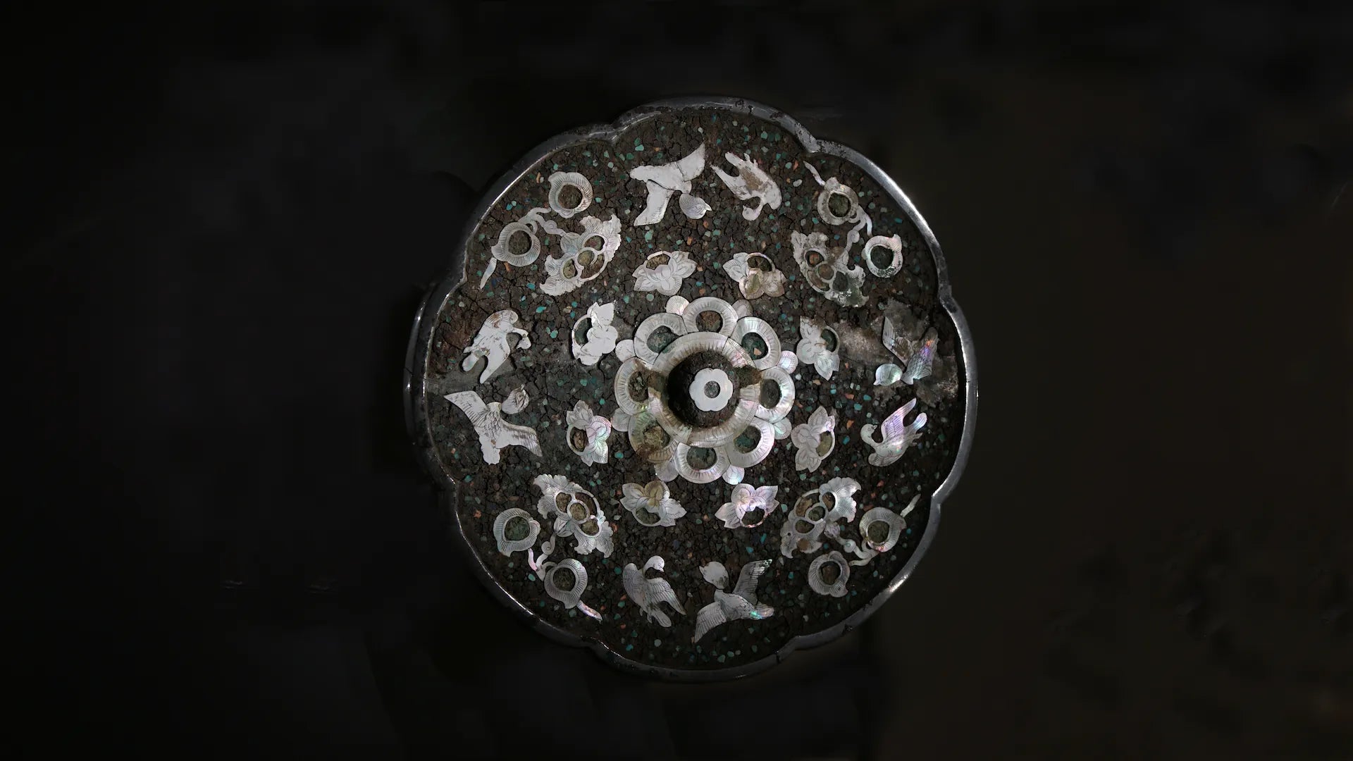 Orienlu official homepage hero banner showcasing an exquisite close-up of a vintage antique Chinese copper mirror with intricate bird and floral mother of pearl inlays against a dark museum-style lighting.
