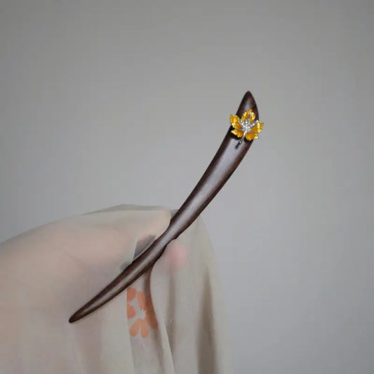Orienlu official product image of a hand-held 15cm red sandalwood hair stick, featuring a handcrafted golden-yellow enamel maple leaf charm with shimmering rhinestone accents.