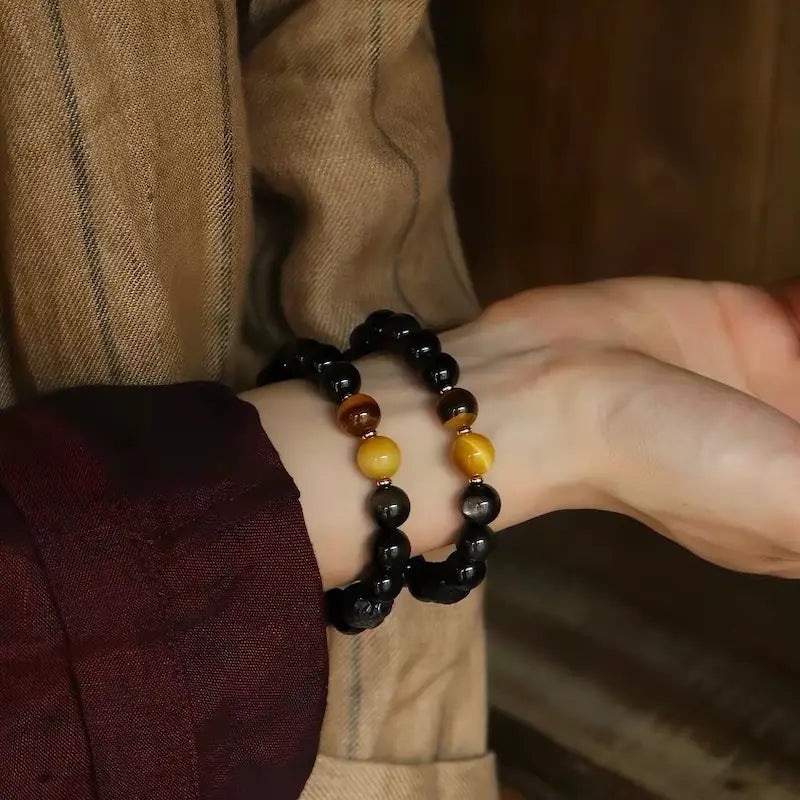Silver sheen obsidian protection bracelet worn on wrist in natural light