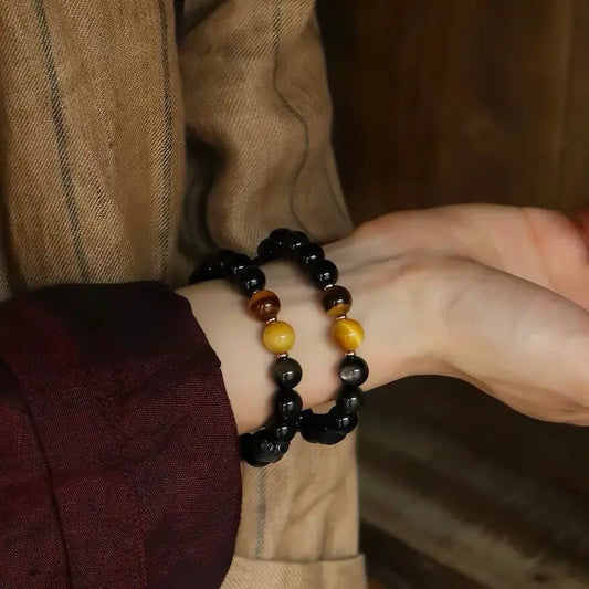 Silver sheen obsidian protection bracelet worn on wrist in natural light