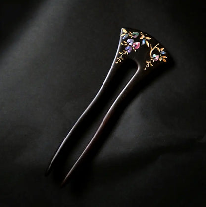 Orienlu official main product image of a neo-Chinese style ebony wood hair fork, featuring exquisite hand-crafted floral mother of pearl inlays with golden leaf accents on a solid black background.