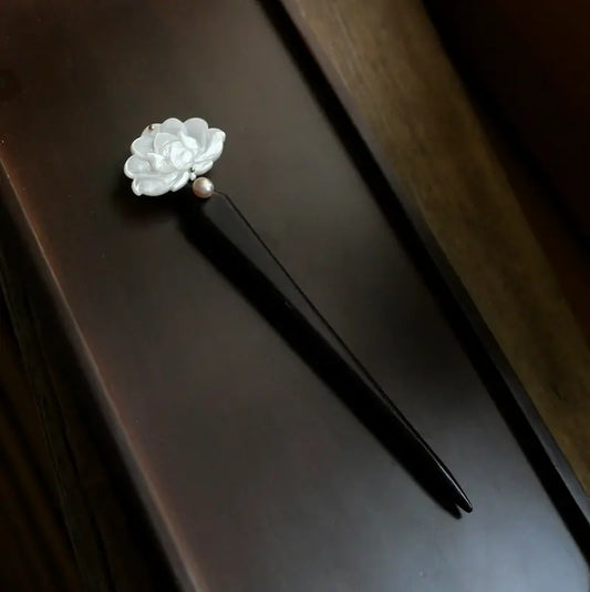 Orienlu official main product image of a 15cm minimalist ebony wood hair stick, featuring a hand-carved white mother of pearl peony flower and a single freshwater pearl.