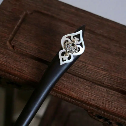 Orienlu official main product shot of a dark ebony wood hair stick, featuring a vintage 925 sterling silver hollow lotus blossom over an iridescent mother of pearl shield.