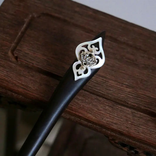 Orienlu official main product shot of a dark ebony wood hair stick, featuring a vintage 925 sterling silver hollow lotus blossom over an iridescent mother of pearl shield.
