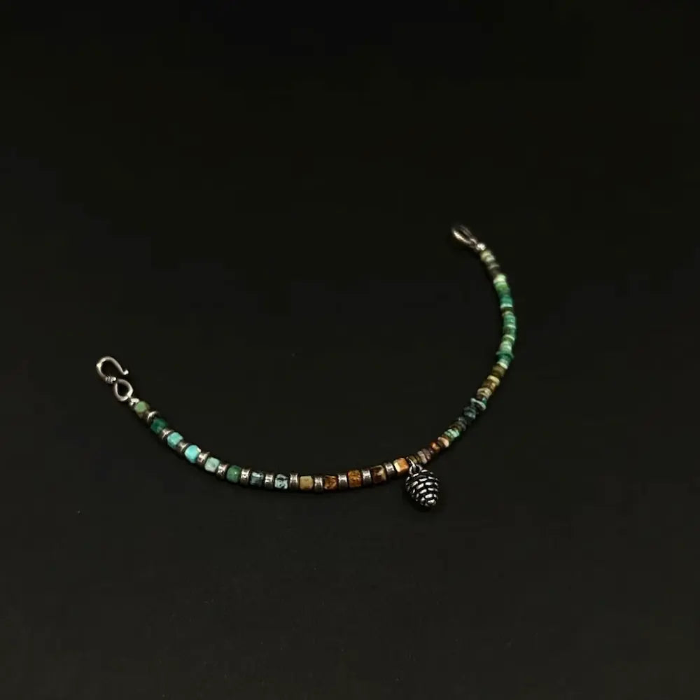 Quartzite abacus bead bracelet unclasped on dark background showing lobster clasp and pinecone pendant Orienlu