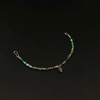 Quartzite abacus bead bracelet unclasped on dark background showing lobster clasp and pinecone pendant Orienlu