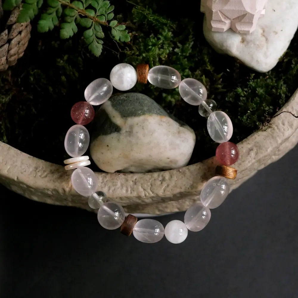 Rose quartz multi-stone bracelet displayed in stone planter with green moss and natural rocks Orienlu