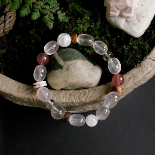 Rose quartz multi-stone bracelet displayed in stone planter with green moss and natural rocks Orienlu