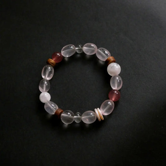 Handcrafted rose quartz bracelet with strawberry quartz and snowflake obsidian on dark background Orienlu
