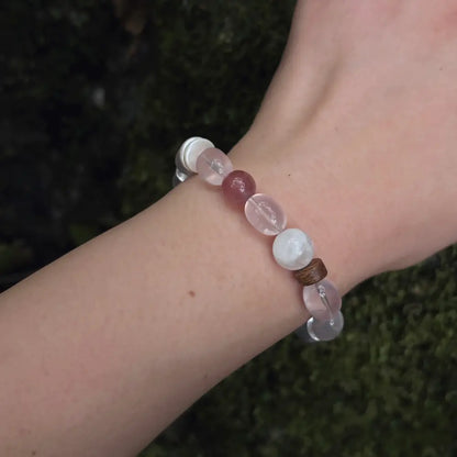 Close-up of rose quartz multi-stone bracelet worn on wrist showing pink beads and agarwood spacers Orienlu