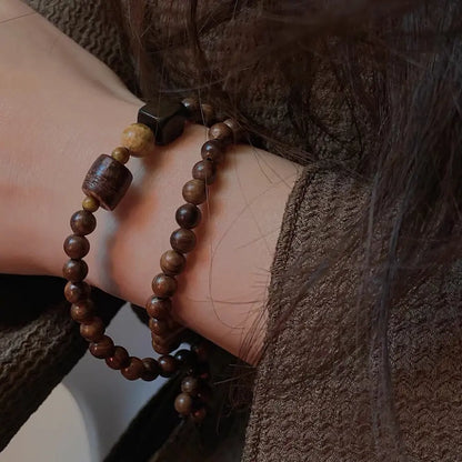 Natural rosewood and tiger eye wrap bracelet worn on wrist with earthy cozy outfit — Orienlu