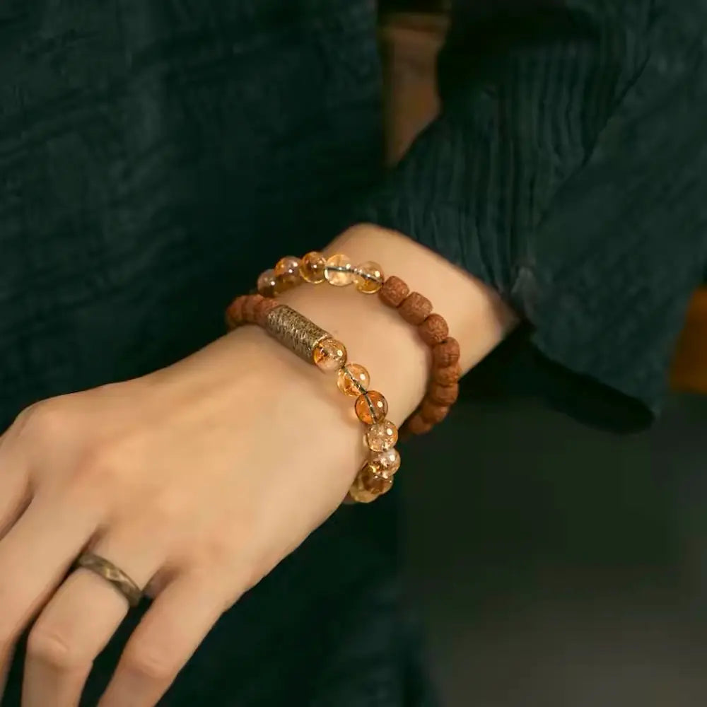 Rudraksha and citrine meditation bracelet worn with natural linen outfit — Orienlu