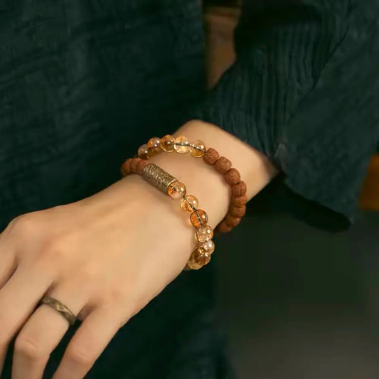 Rudraksha and citrine meditation bracelet worn with natural linen outfit — Orienlu