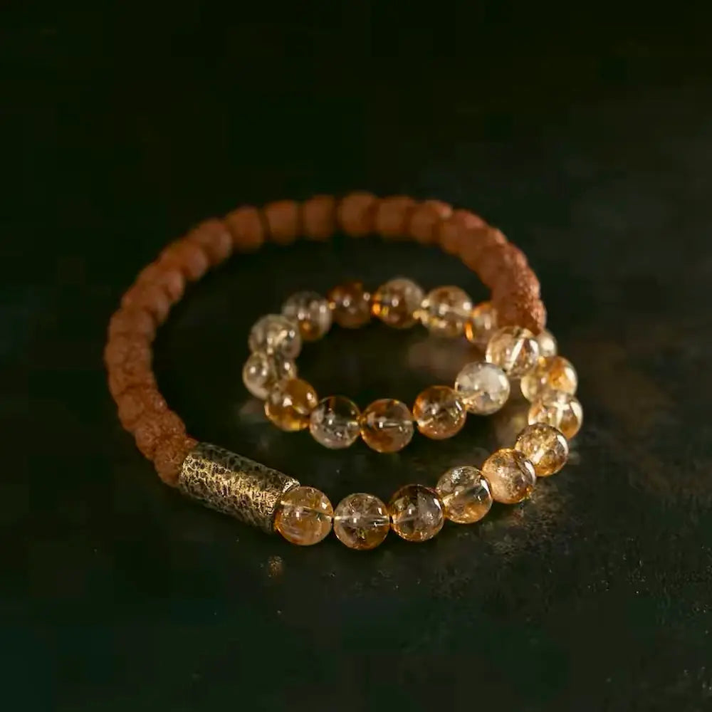 Close-up of textured rudraksha seeds and polished citrine beads on meditation bracelet — Orienlu