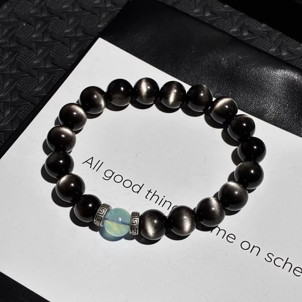 Handcrafted silver sheen obsidian bracelet with aquamarine and vintage alloy spacers on white card Orienlu