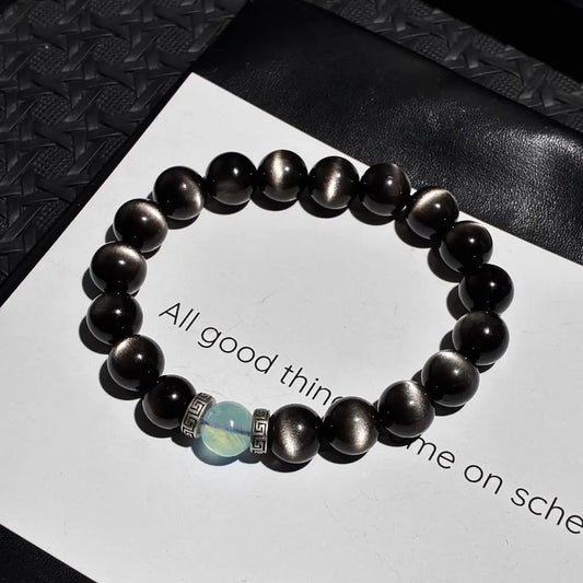 Handcrafted silver sheen obsidian bracelet with aquamarine and vintage alloy spacers on white card Orienlu