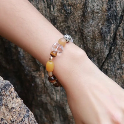 Tiger eye multi-stone beaded bracelet worn on wrist against natural rock background Orienlu