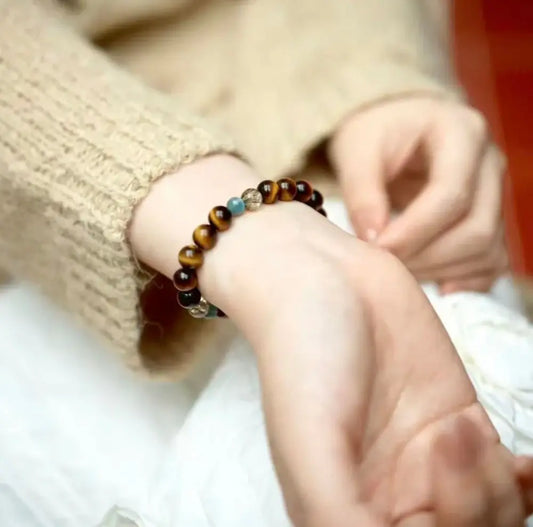 Real tiger eye bracelet worn on wrist showing golden brown and blue tones Orienlu